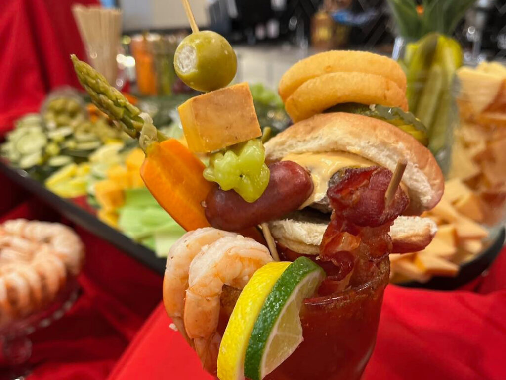 Enjoy a Bloody Mary cocktail and some scrumptious appetizers. Shrimp and mini slider sandwiches.